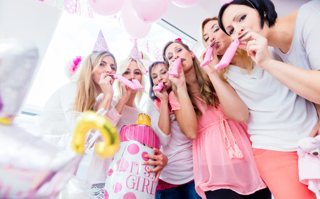 group of women having fun playing games at a baby shower