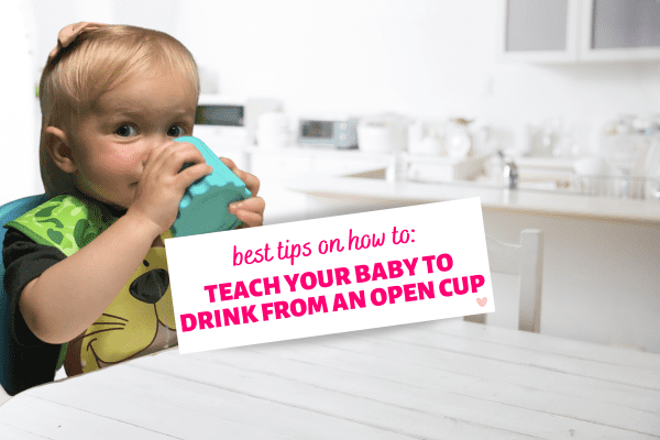 How to Teach Your Baby to Drink from an Open Cup - image shows cute baby girl in white kitchen drinking from an open cup