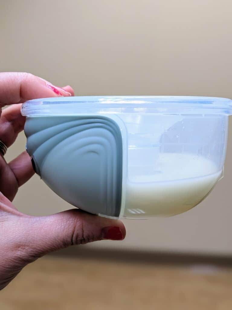 mommed s12 review showing breast milk held in container of pump